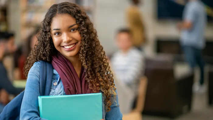 Student smiling in the university library