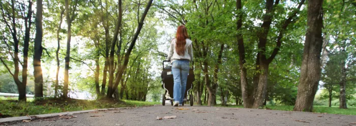 Woman in park with a pushchair